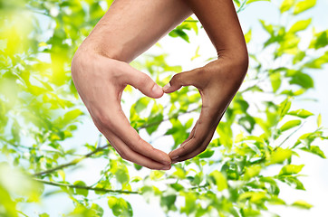 Image showing hands of different skin color making heart shape