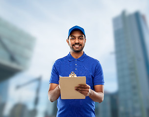 Image showing happy indian delivery man with clipboard in blue