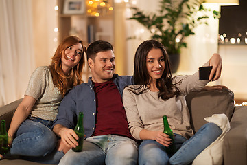 Image showing happy friends taking selfie by smartphone at home