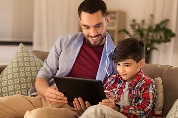 Image showing father and son listening to music on tablet pc