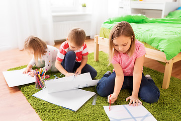 Image showing children drawing and making crafts at home