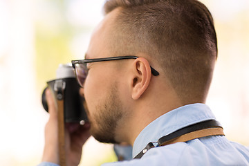 Image showing photographer with film camera making shot