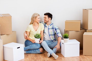 Image showing happy couple with boxes moving to new home