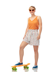 Image showing smiling teenage girl with skateboard over white