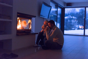 Image showing happy couple in front of fireplace