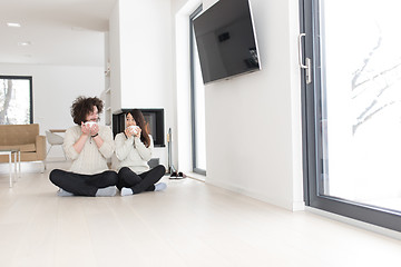 Image showing happy multiethnic couple  in front of fireplace