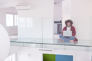 Image showing young freelancer in bathrobe working from home