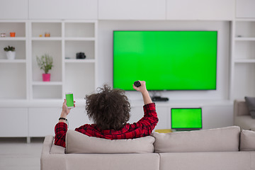 Image showing young man in bathrobe enjoying free time