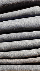 Image showing Close up of stack of blue jeans