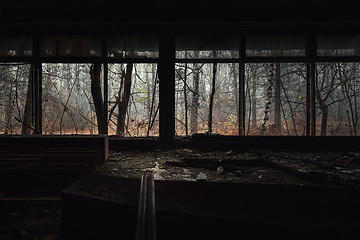 Image showing Abandoned building interior with autumnal forest outside