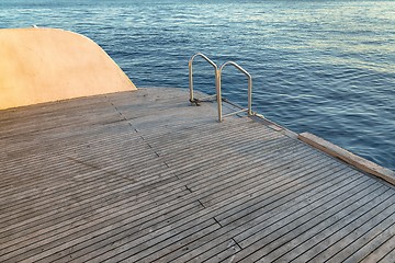 Image showing Wet boat deck against blue ocean