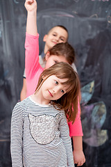 Image showing group of kids standing in front of chalkboard