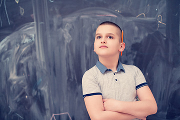 Image showing portrait of little boy in front of chalkboard