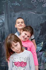 Image showing group of kids standing in front of chalkboard