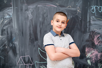 Image showing portrait of little boy in front of chalkboard