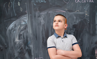 Image showing portrait of little boy in front of chalkboard