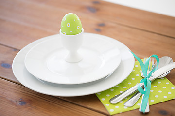 Image showing easter egg in cup holder, plates and cutlery