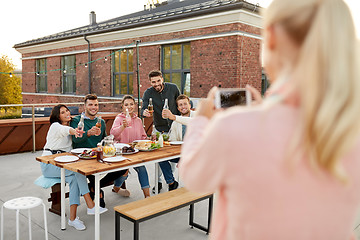 Image showing happy friends photographing at rooftop party