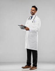 Image showing smiling indian male doctor with tablet computer