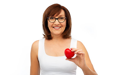 Image showing portrait of smiling senior woman holding red heart