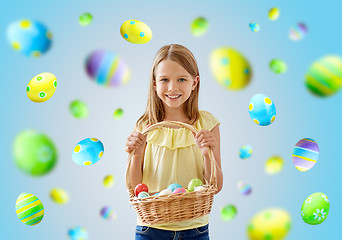 Image showing happy girl with colored eggs in wicker basket