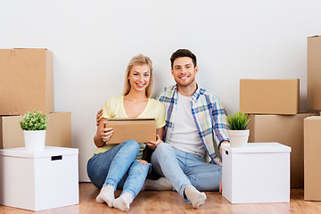 Image showing happy couple with boxes moving to new home