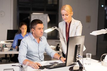 Image showing business team with computer working late at office