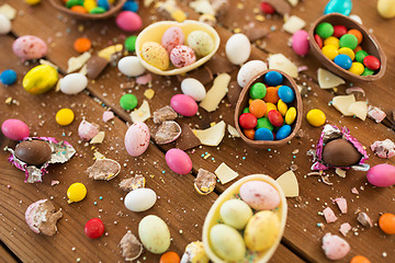 Image showing chocolate eggs and candy drops on wooden table