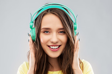 Image showing happy young woman or teenage girl with headphones