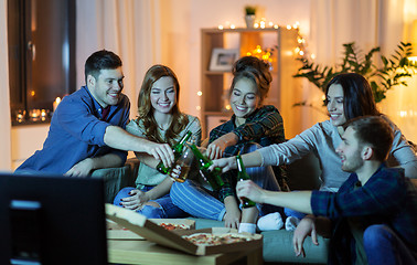 Image showing friends with drinks and pizza watching tv at home