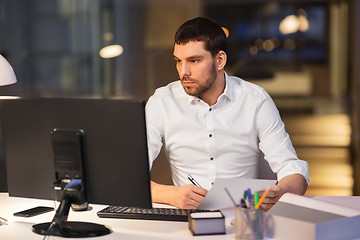 Image showing businessman with computer working at night office