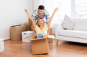 Image showing happy couple having fun with boxes at new home