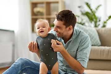 Image showing happy father holding little baby daughter at home