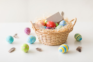 Image showing easter eggs and greeting card in basket