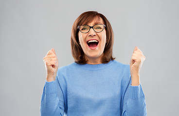 Image showing portrait of happy senior woman celebrating triumph