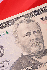 Image showing fifty dollar bill in front of the American flag