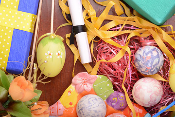 Image showing Handcrafted easter eggs close up, ribbons and decoration