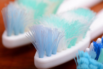 Image showing xtreme Macro close up of toothbrush with wooden background