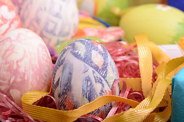 Image showing Handcrafted easter eggs close up, ribbons and decoration