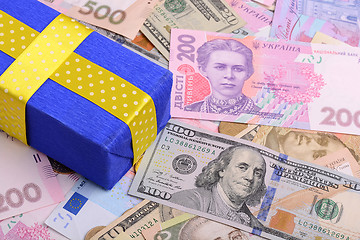 Image showing banknotes, clear image of dollars and new bills Ukrainian national currency hryvnia with gift box