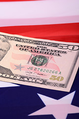 Image showing fifty dollar bill in front of the American flag