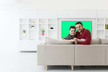 Image showing couple hugging and relaxing on sofa