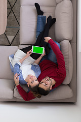Image showing couple relaxing at  home with tablet computers