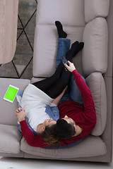 Image showing Young couple on the sofa watching television top view