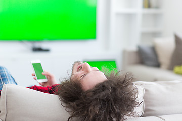 Image showing young man in bathrobe enjoying free time