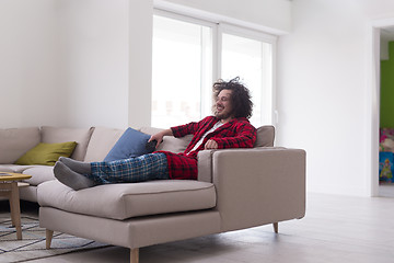 Image showing young man in bathrobe enjoying free time