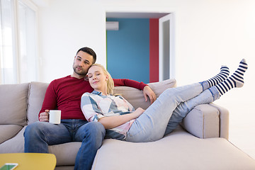 Image showing couple hugging and relaxing on sofa