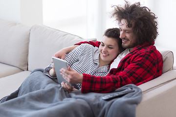 Image showing couple relaxing at  home with tablet computers