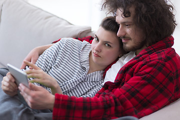 Image showing couple relaxing at  home with tablet computers