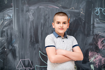 Image showing portrait of little boy in front of chalkboard